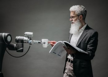 A scientist interacts with a robot helper, demonstrating modern technological innovation.