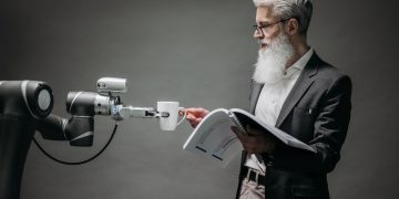 A scientist interacts with a robot helper, demonstrating modern technological innovation.