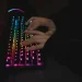 Close-up of hands typing on a colorful RGB backlit mechanical keyboard in a dimly lit environment.