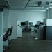 An empty modern office space in Kyiv featuring workstations, chairs, and technology.
