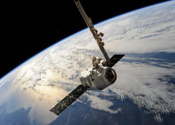 A satellite glides over Earth showcasing dramatic cloud formations and the vast expanse of space.