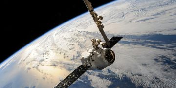 A satellite glides over Earth showcasing dramatic cloud formations and the vast expanse of space.