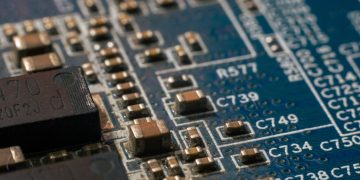 Detailed macro shot of a circuit board highlighting electronic components and traces.