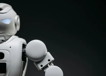 Close-up of a modern, monochrome robot arm against a dark background. Futuristic technology concept.