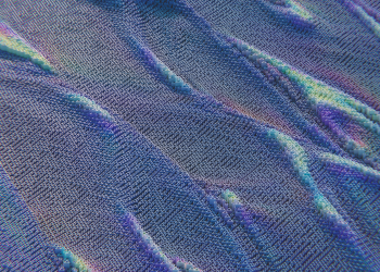 Colorful abstract pattern resembling digital waves with intricate texture in blue and purple hues.
