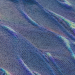 Colorful abstract pattern resembling digital waves with intricate texture in blue and purple hues.