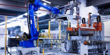blue industrial robot arm in factory