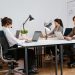 Team of diverse call center agents working diligently in a modern office setting.