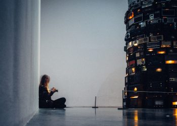 man in black jacket sitting on black chair