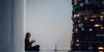 man in black jacket sitting on black chair