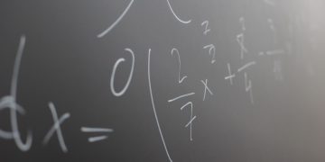 Blackboard with handwritten mathematical example for solve on lesson during studies in classroom of university