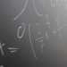 Blackboard with handwritten mathematical example for solve on lesson during studies in classroom of university