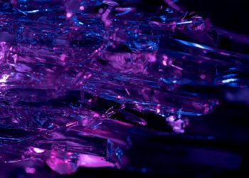 Stunning macro shot of purple and blue crystals, revealing intricate textures and vibrant colors.