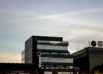 Contemporary architecture showcasing Amazon office at dusk in Iași, Romania.