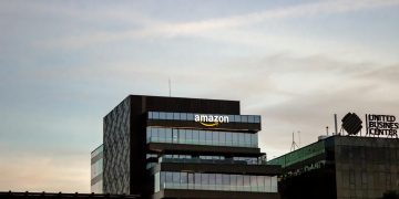 Contemporary architecture showcasing Amazon office at dusk in Iași, Romania.