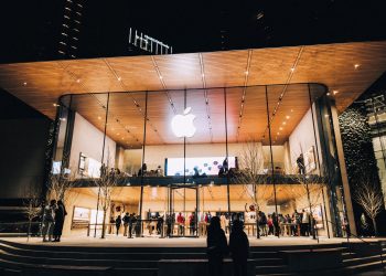 Vibrant night scene of an Apple Store in Vancouver, highlighting modern architecture and urban lifestyle.