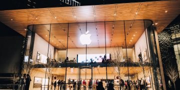 Vibrant night scene of an Apple Store in Vancouver, highlighting modern architecture and urban lifestyle.