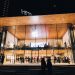 Vibrant night scene of an Apple Store in Vancouver, highlighting modern architecture and urban lifestyle.