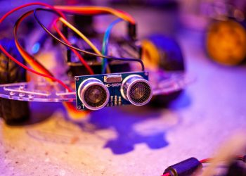 Detailed view of a robotic vehicle component showcasing wires and sensors.