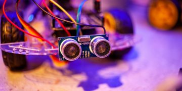 Detailed view of a robotic vehicle component showcasing wires and sensors.
