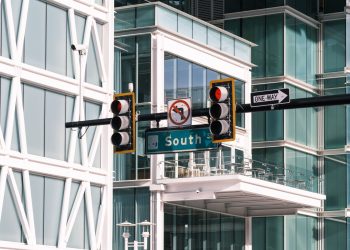Contemporary intersection with traffic signals at South Street, featuring urban architecture and glass buildings.