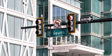 Contemporary intersection with traffic signals at South Street, featuring urban architecture and glass buildings.