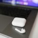 A close-up shot of wireless earbuds and case on a laptop, perfect for tech themes.