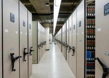 Spacious library archive with organized compact shelving and storage units.