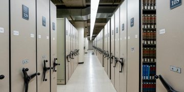 Spacious library archive with organized compact shelving and storage units.