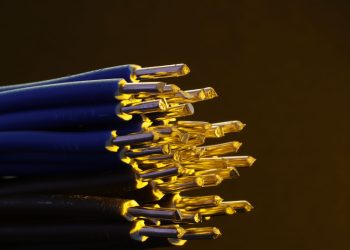 Detailed view of blue ethernet cables with exposed gold-plated conductors.