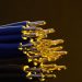 Detailed view of blue ethernet cables with exposed gold-plated conductors.