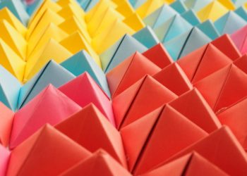 Vibrant folded paper pyramids in a colorful geometric pattern.