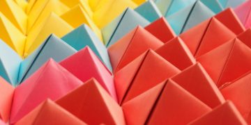 Vibrant folded paper pyramids in a colorful geometric pattern.
