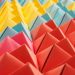 Vibrant folded paper pyramids in a colorful geometric pattern.