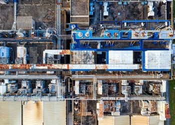 Aerial view of modern industrial factory with buildings and various special equipments in daytime
