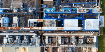 Aerial view of modern industrial factory with buildings and various special equipments in daytime