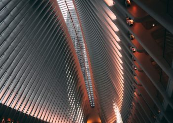 Futuristic interior of a modern building with steel beams and ambient lighting.