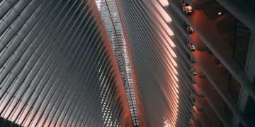 Futuristic interior of a modern building with steel beams and ambient lighting.