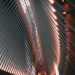 Futuristic interior of a modern building with steel beams and ambient lighting.