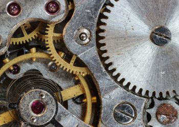 Detailed close-up of interlocking gears and cogs in a complex mechanical system.