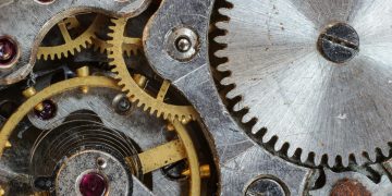 Detailed close-up of interlocking gears and cogs in a complex mechanical system.