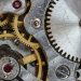 Detailed close-up of interlocking gears and cogs in a complex mechanical system.