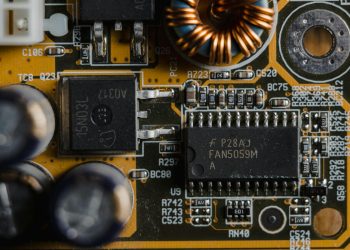 Detailed view of microchips and components on a motherboard circuit board.