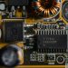 Detailed view of microchips and components on a motherboard circuit board.