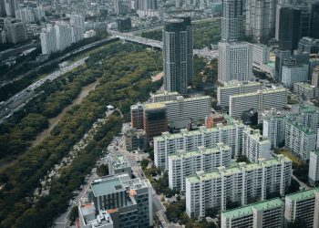 Aerial view of modern skyscrapers and lush greenery in Seoul, South Korea.