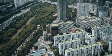Aerial view of modern skyscrapers and lush greenery in Seoul, South Korea.