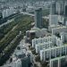 Aerial view of modern skyscrapers and lush greenery in Seoul, South Korea.
