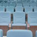 Rows of modern blue theater seats in an empty auditorium, highlighting architectural design.