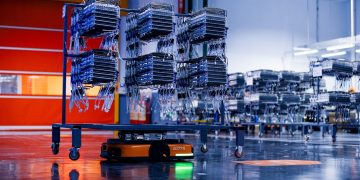 a large group of boxes sitting on top of a conveyor belt