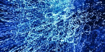 Vivid abstract image of dynamic blue light patterns creating a captivating visual effect.